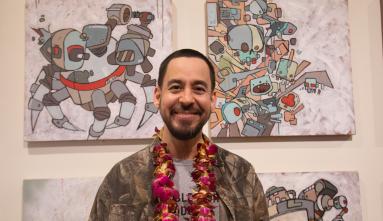 mike shinoda in front of his art